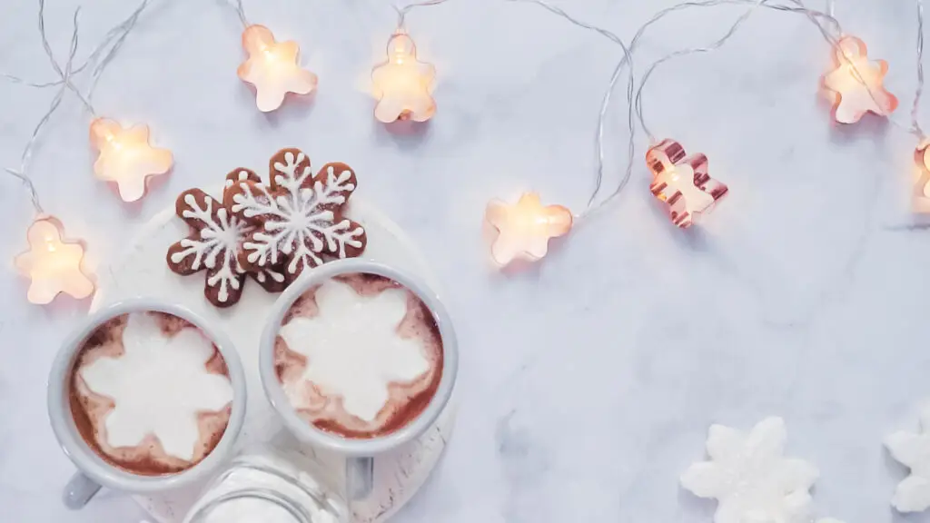 Calm winter evening with warm lights and a mugs of hot chocolate