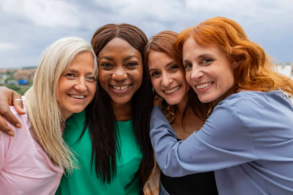 Group of diverse women smiling.