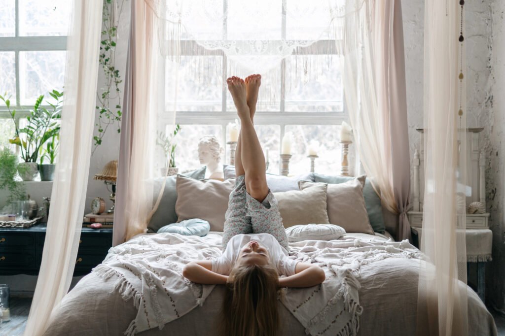 Person practicing Legs Up the Wall pose as part of a relaxing bedtime routine.