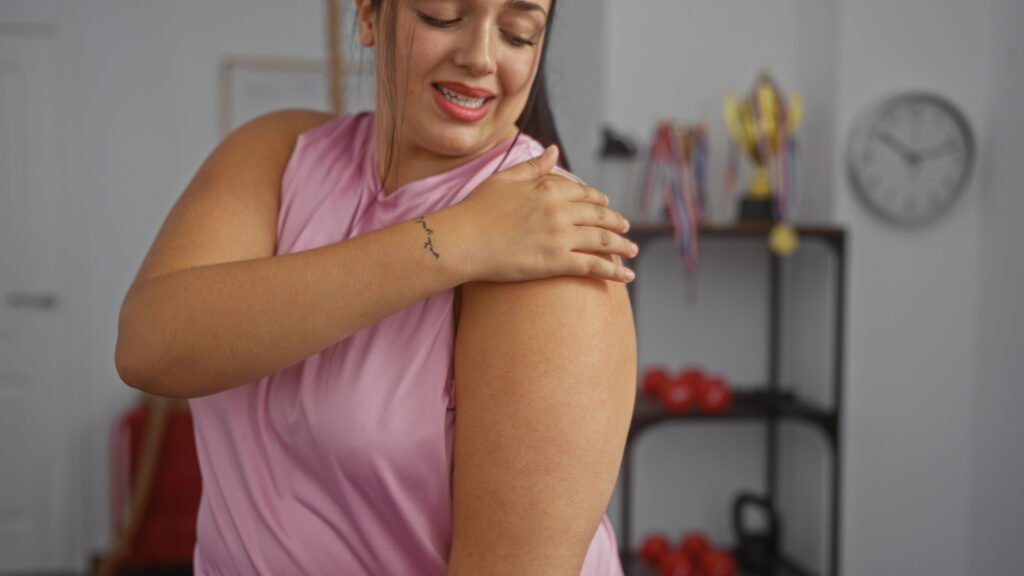 Woman using mindful touch to notice body sensations during a somatic yoga practice.