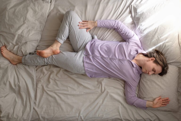 Person doing a gentle spinal twist on a bed before sleep.